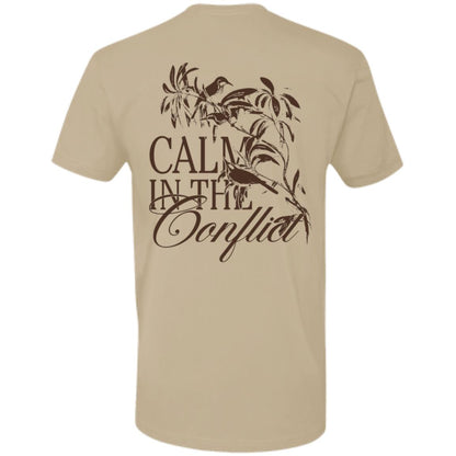 The Calm In The Conflict - Sand tee, crafted from premium ring-spun cotton in a soothing beige shade, showcases the phrase "Calm in the Conflict" along with an artful depiction of a bird and branches on the back. Embrace serenity amidst turmoil with this beautifully designed t-shirt.