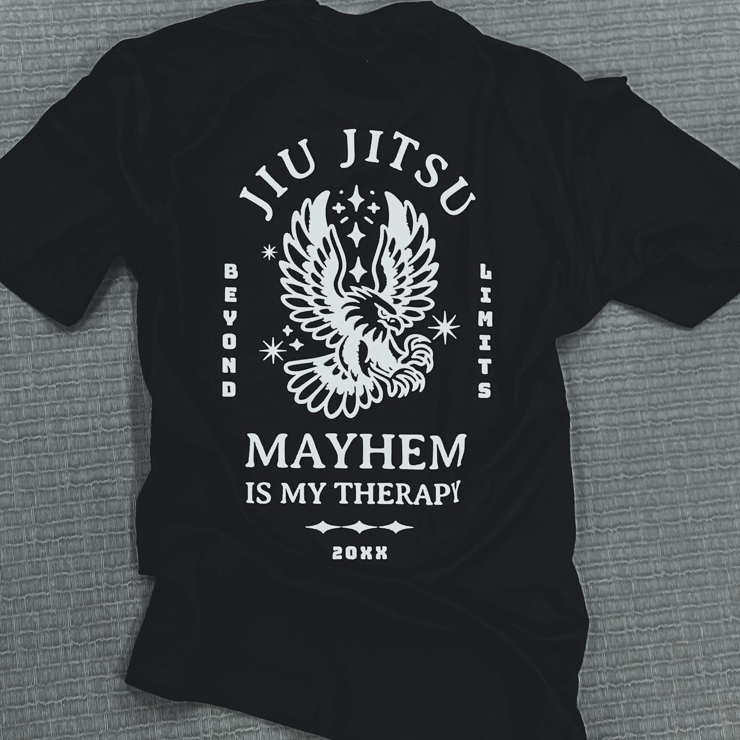 Beyond Limits - Black T-shirt featuring a striking white eagle design and bold lettering: 'Jiu Jitsu,' 'Beyond Limits,' and 'Mayhem is My Therapy.' Show your passion for Jiu Jitsu and prove that you're always pushing beyond limits.