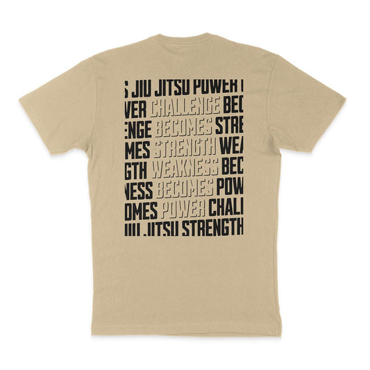 A tan Strength & Power - Sand shirt with black text on it, embodying the strength of a Jiu Jitsu practitioner.