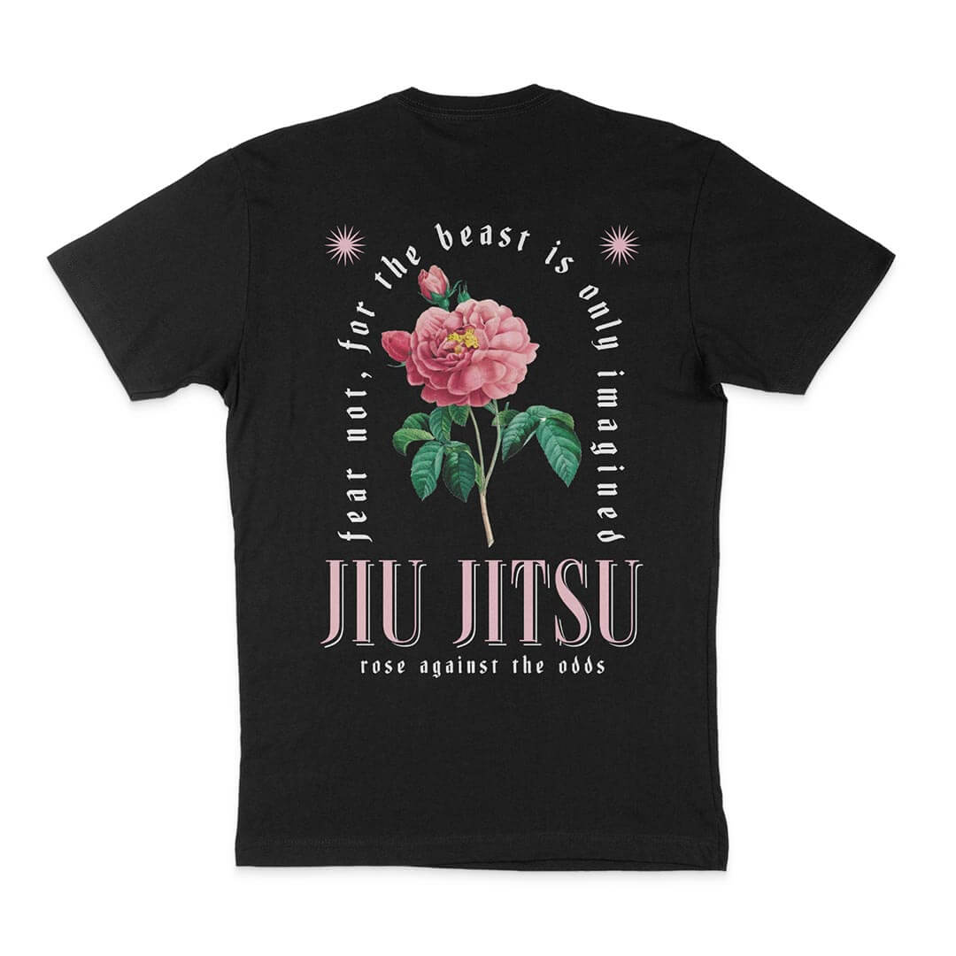 The Beast Is Only Imagined - Black with a graphic of an enchanted pink rose and green leaves. Text reads, "Fear not, for the beast is only imagined. Jiu Jitsu. Rose against the odds." Perfect for those who believe in overcoming adversity through strength and resilience.